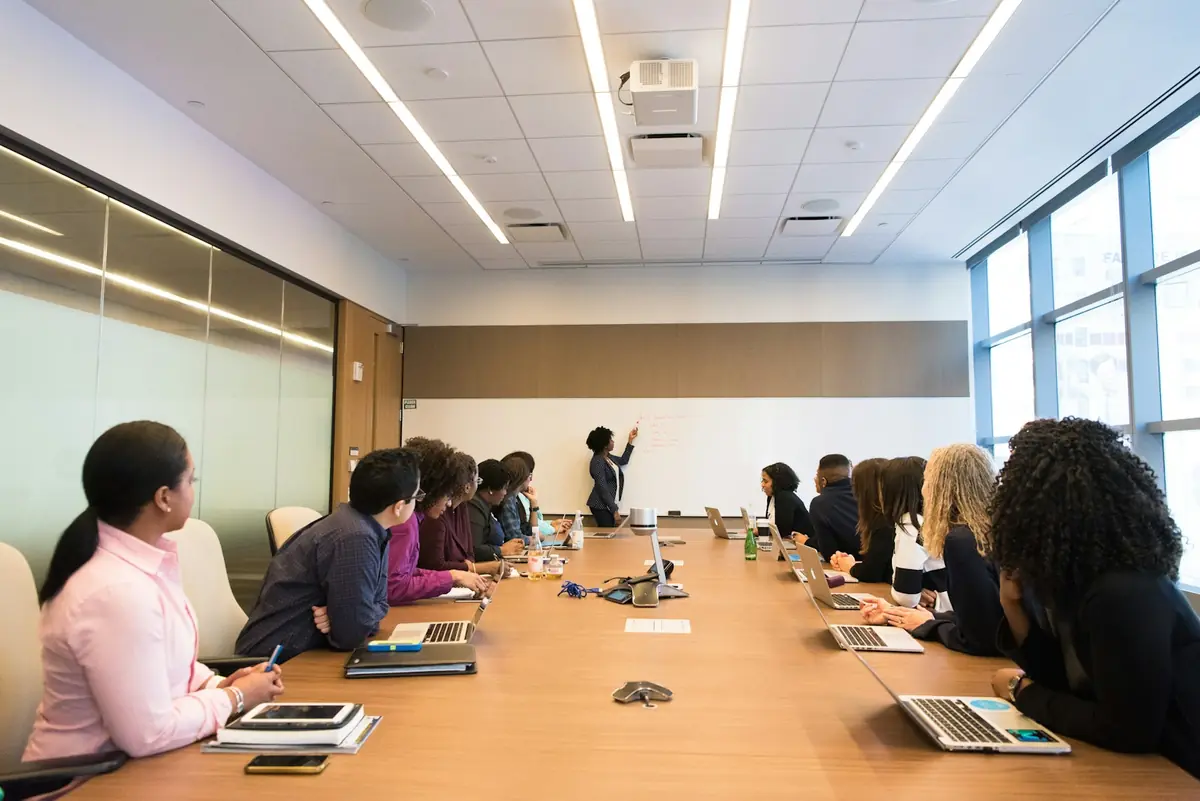 A facilitator leading a workshop with a group of managers